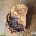 Plaque de peau de bœuf séchée présentée sur une table.